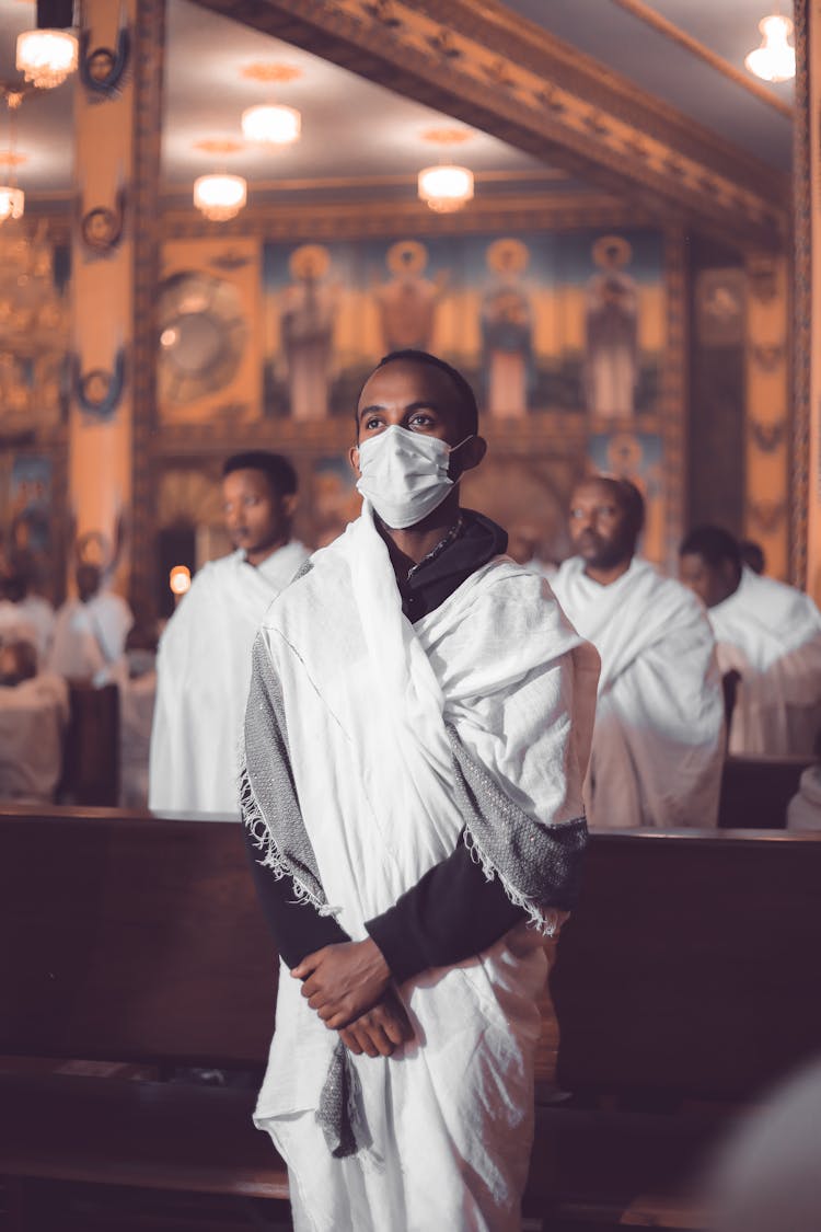 Man In Wrap Around White Cloth Wearing White Mask