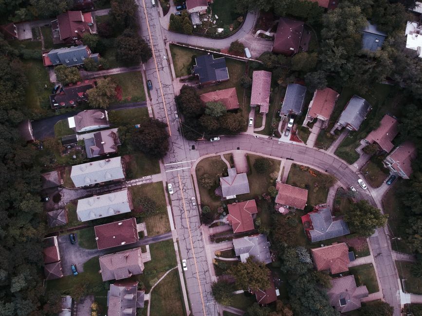 suburban neighborhood cul-de-sac with neighbors watching street incident