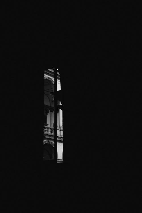 Free Building Seen through Window in Darkness Stock Photo