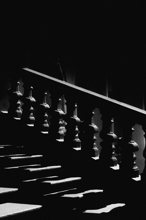 Free Grayscale image of a dramatic staircase in Milan with striking shadows and light contrasts. Stock Photo