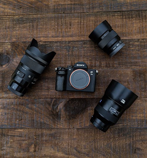 Camera and Lenses on a Wooden Surface