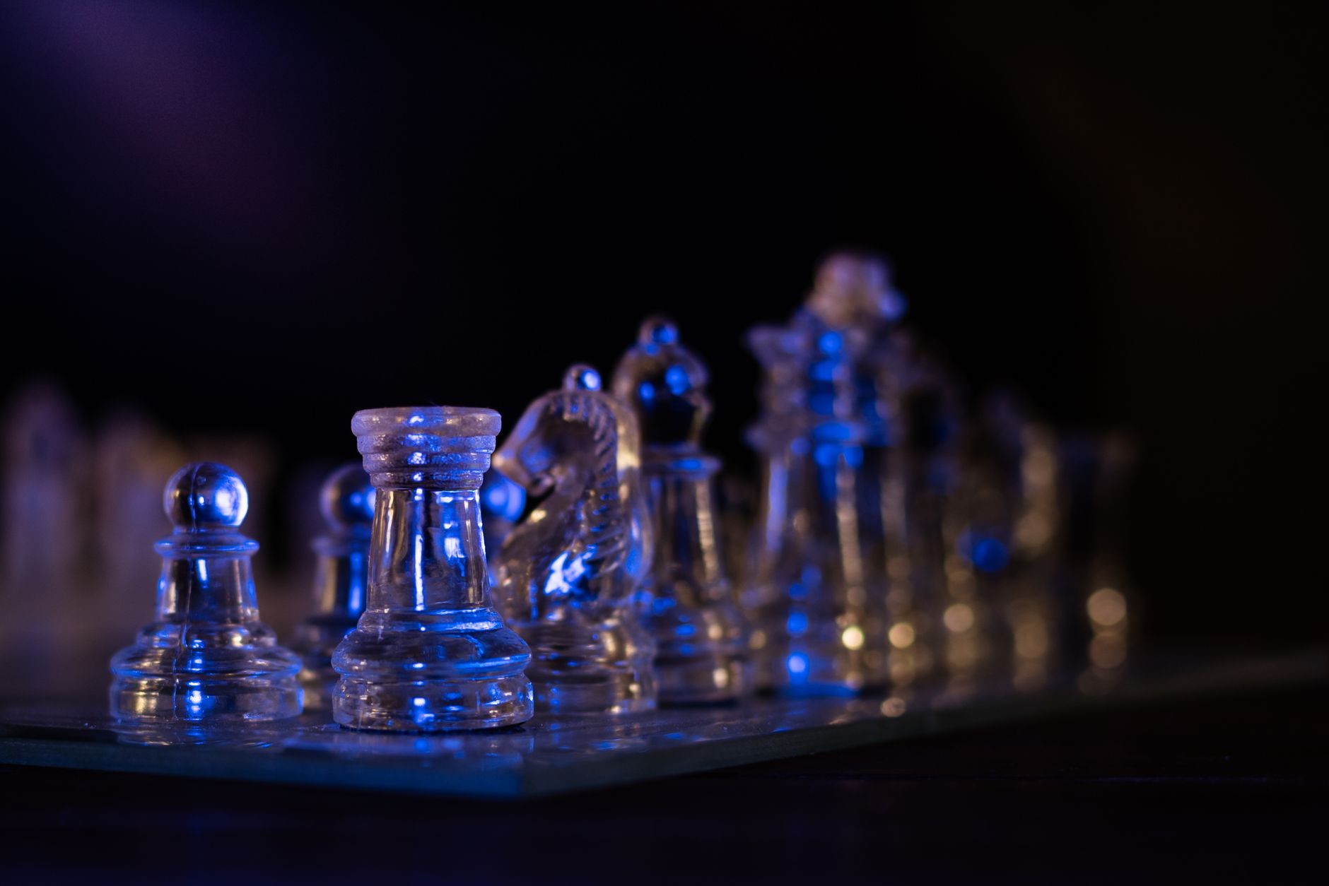 methylene blue for long covid brain fog recovery — Transparent glass chess pieces with blue lighting create a striking and modern still life image.