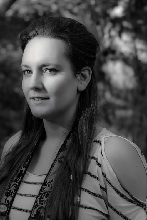 Free Monochrome portrait of a woman with long hair outdoors, featuring natural lighting and a calm expression. Stock Photo