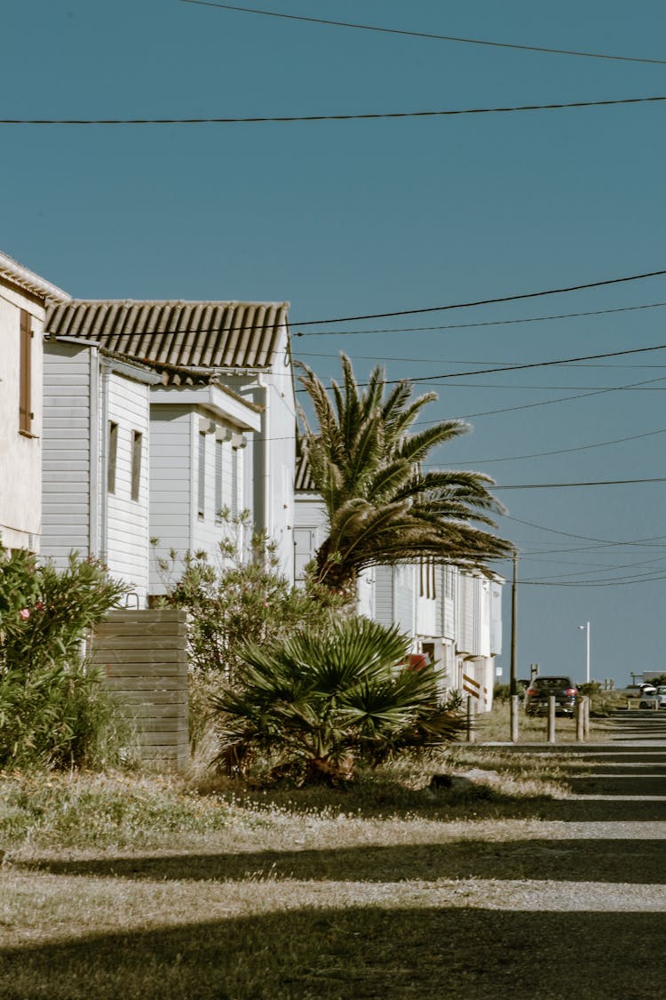 A Row Of White Houses Under The Clear Blue Sky 