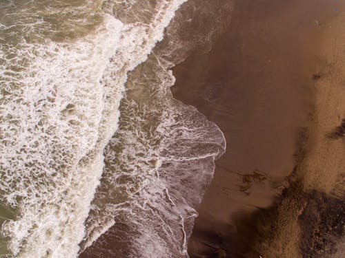 Crashing Waves on Brown Sand