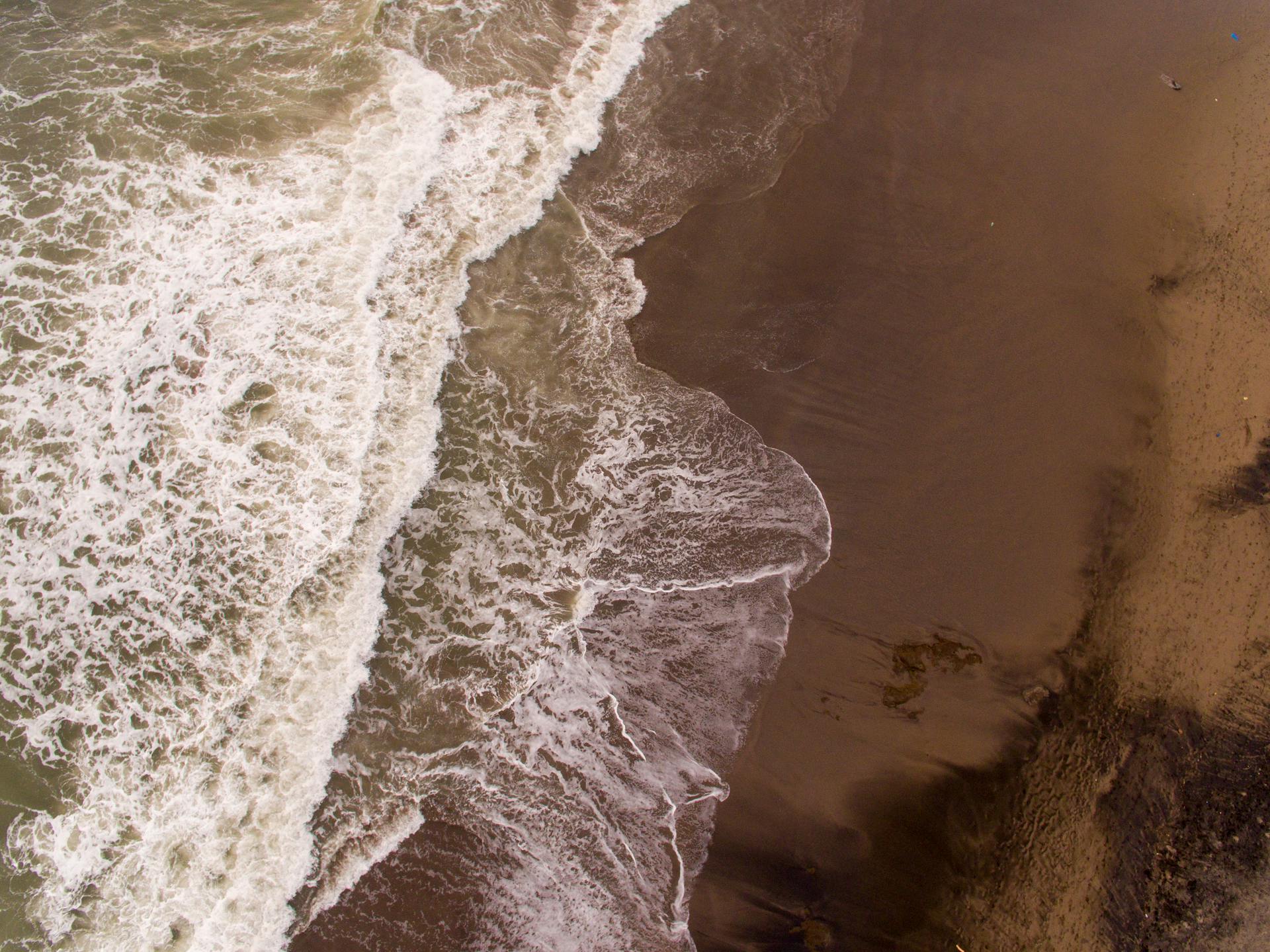 Crashing Waves on Brown Sand