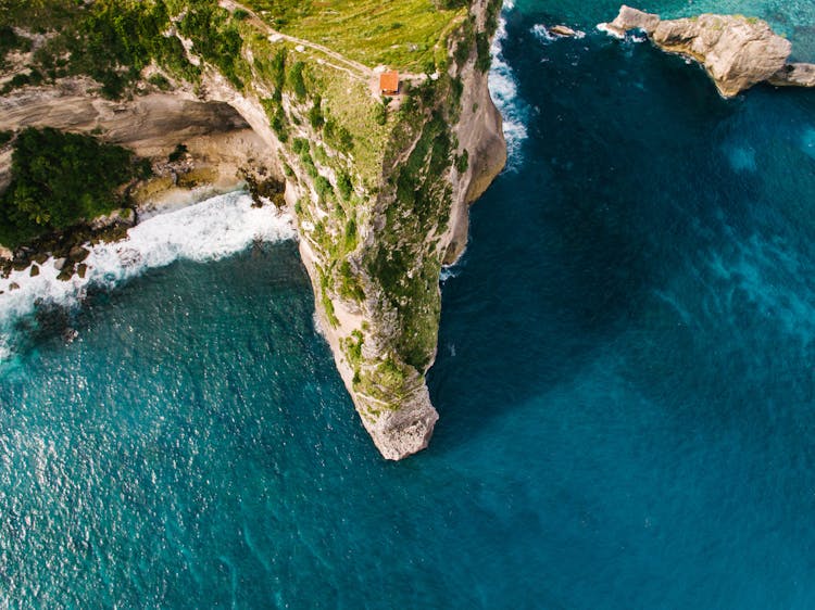 Drone Shot Of An Orange House On A Cliff