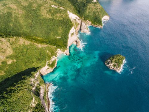 Free Breathtaking aerial view of cliffs and turquoise ocean along a remote coastline. Stock Photo