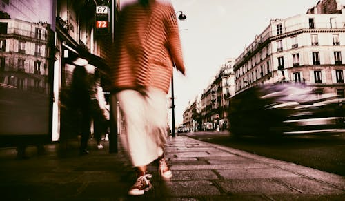 A Person Wearing Converse All Star Walking on Pavement