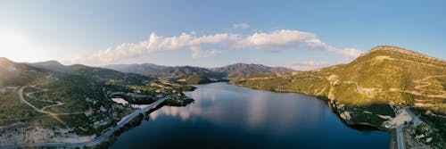 An Aerial Photography of a Lake Between Mountains Under the Blue Sky