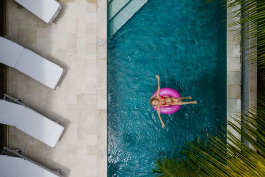 A Woman in Red Bikini Chilling on Pool