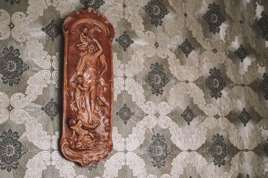 Elegant vintage wall decor on ornate wallpaper. Perfect for classic interiors.