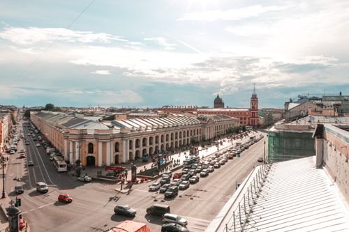 Free A vibrant aerial view of a busy European street showcasing historic architecture under a blue sky. Stock Photo