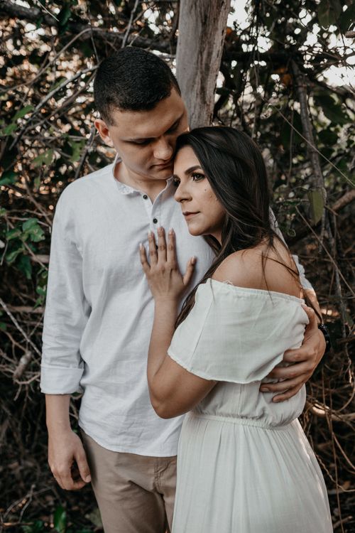 Free A couple embracing outdoors in a forest, conveying deep affection and connection. Stock Photo
