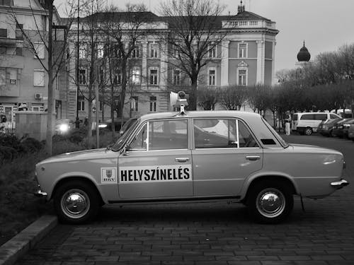 Sedan Near the Concrete Buidling