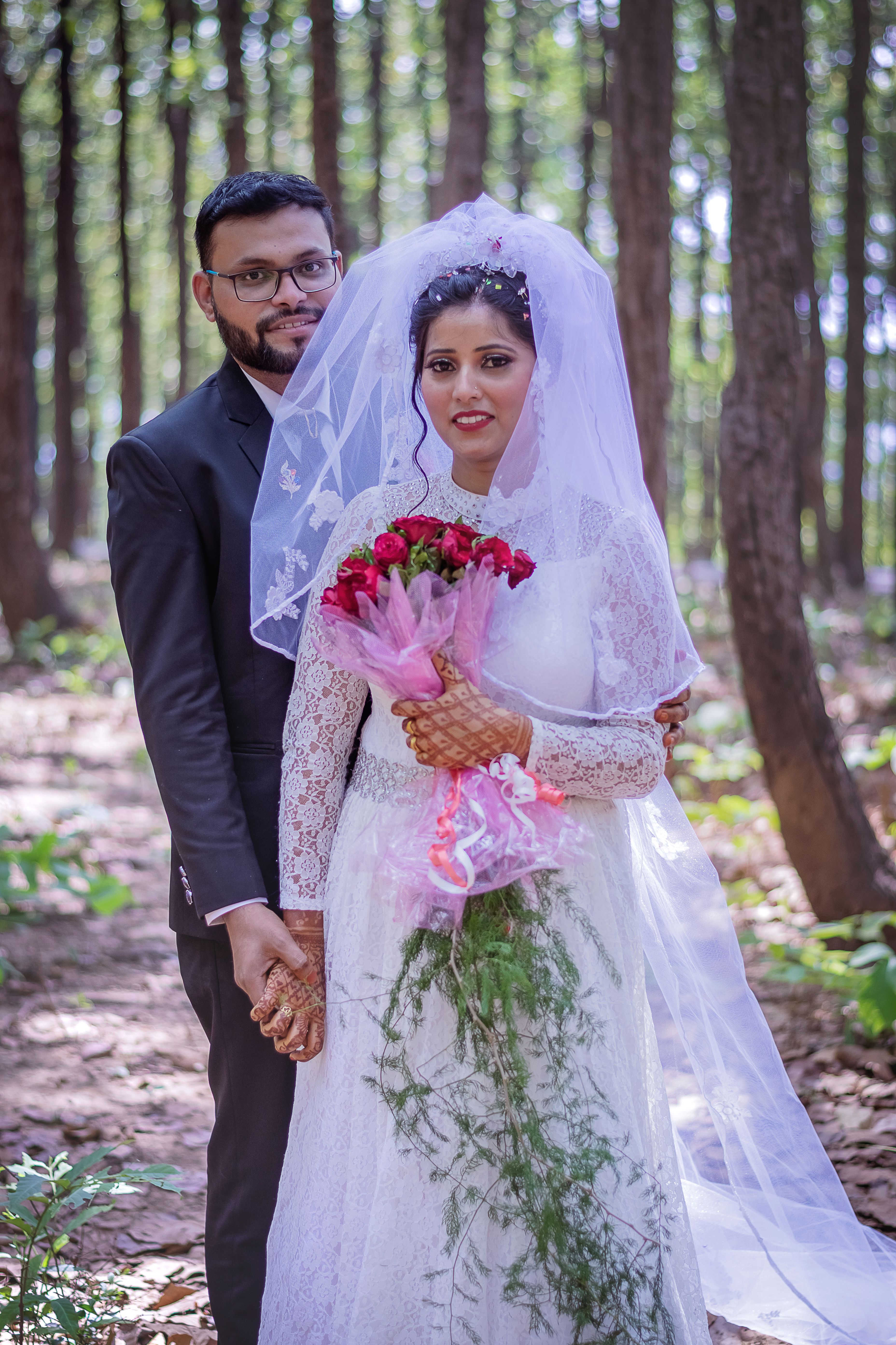 A Bride and Groom Standing in the Forest · Free Stock Photo