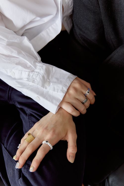 Free Close-up of two hands adorned with stylish rings and bracelets, showcasing elegance. Stock Photo