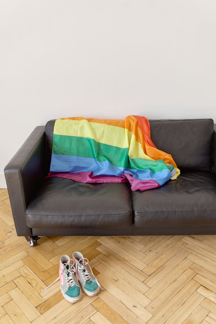 A Colorful Scarf On A Leather Couch