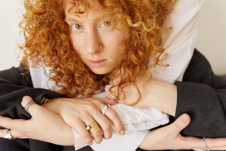 A Woman With Curly Hair And Nose Rings