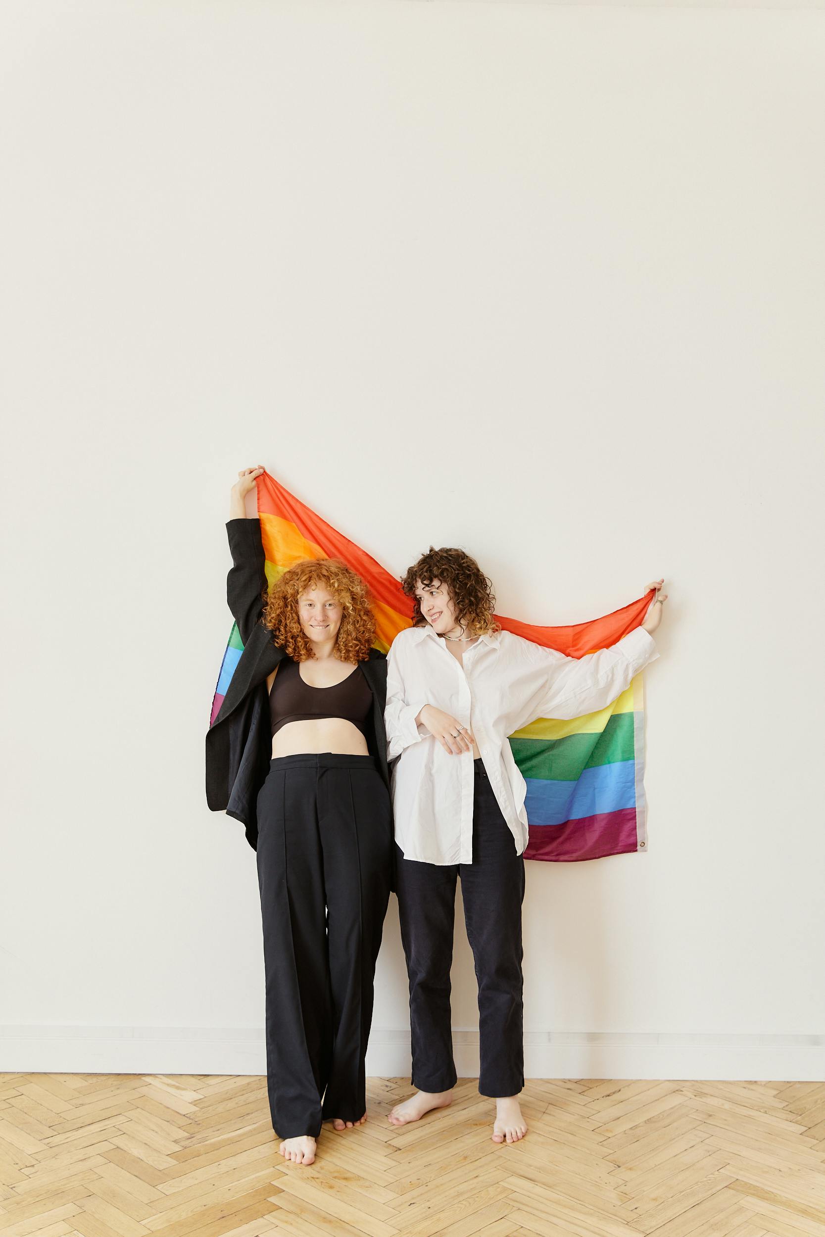 women holding a rainbow flag