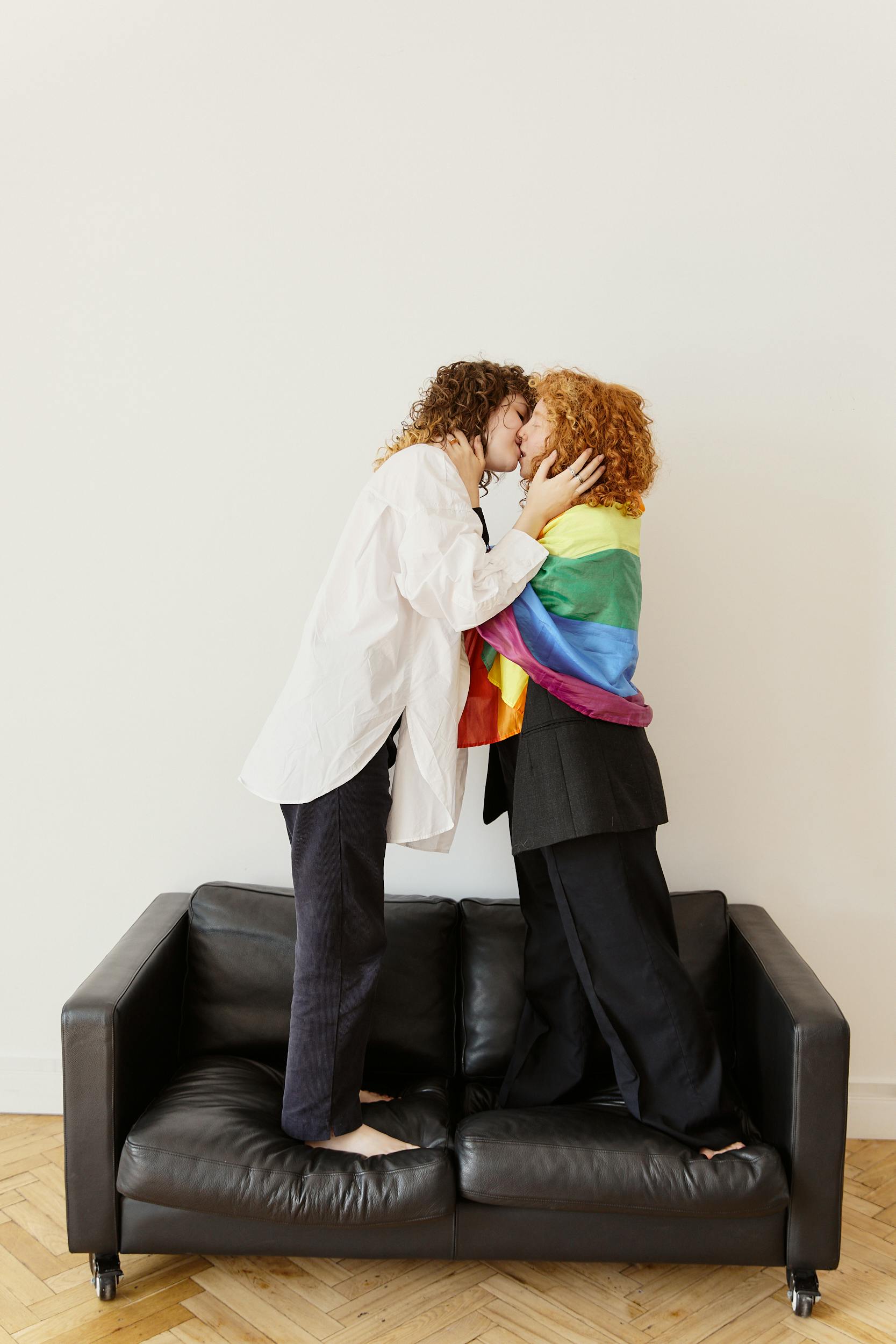 a couple kissing on a couch