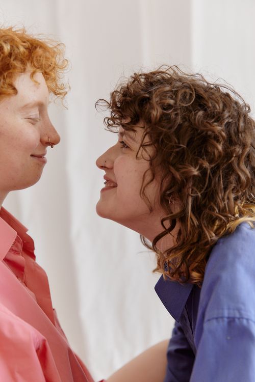 Free Happy lesbian couple sharing a tender moment indoors. Celebrate love and diversity with this intimate snapshot. Stock Photo