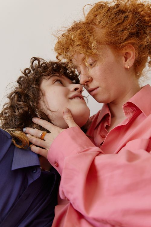 Free Two women sharing a tender moment in a loving embrace, expressing intimacy indoors. Stock Photo