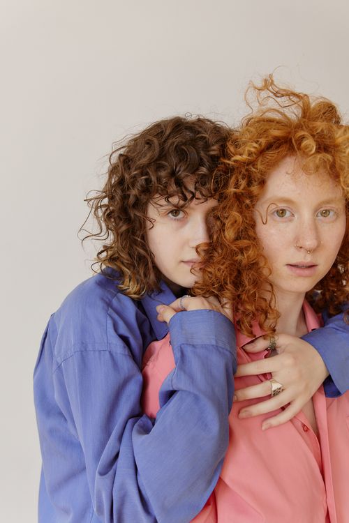 Free Close-up of two women embracing, showcasing love and diversity with colorful attire. Stock Photo
