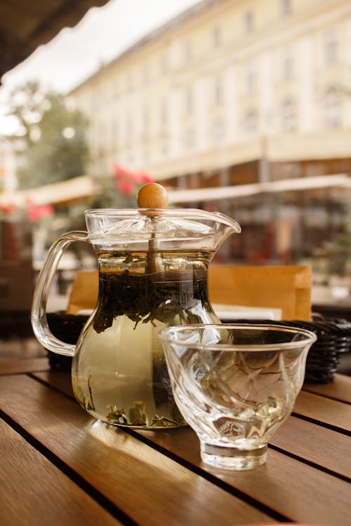 Free Glass Cup Beside a Glass Pitcher with Tea Stock Photo