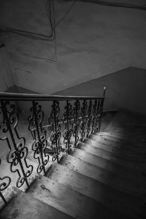 Grayscale Photo of Staircase With Railings