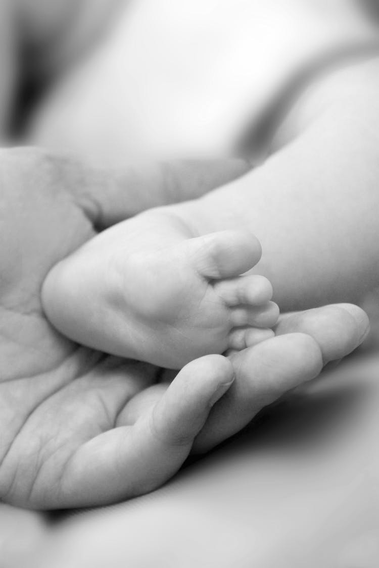 Grayscale Photo Of Baby's Feet