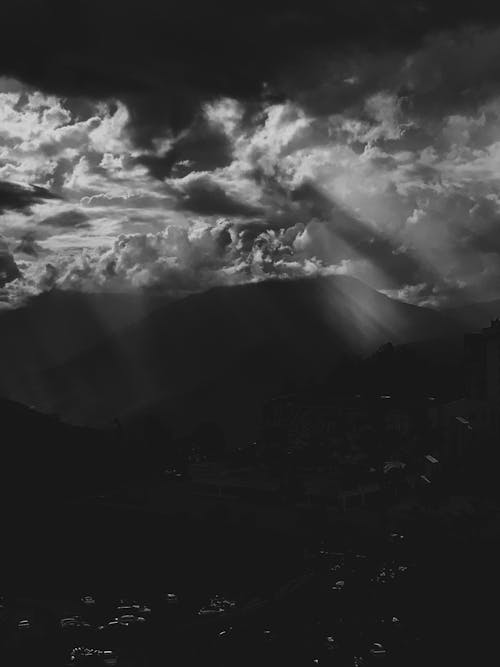 Grayscale Photo of Clouds over Mountains