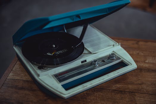 A retro analog record player placed on a wooden table, evoking nostalgia.