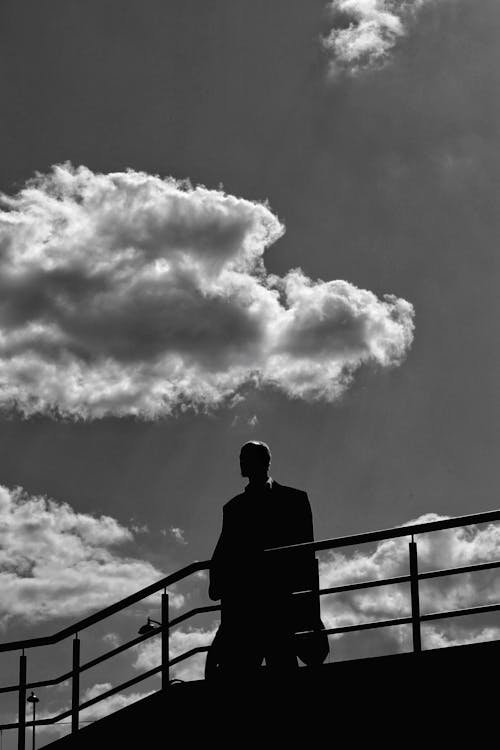 Grayscale Photo of Silhouetted Man 