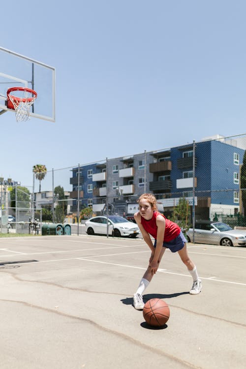 Girl Stretching on Basketball Court 