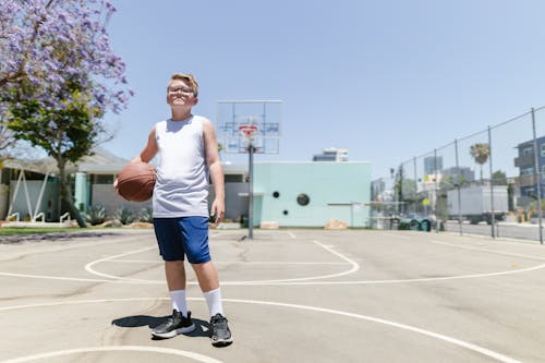 Boy in White Tank Top Holding Basketball