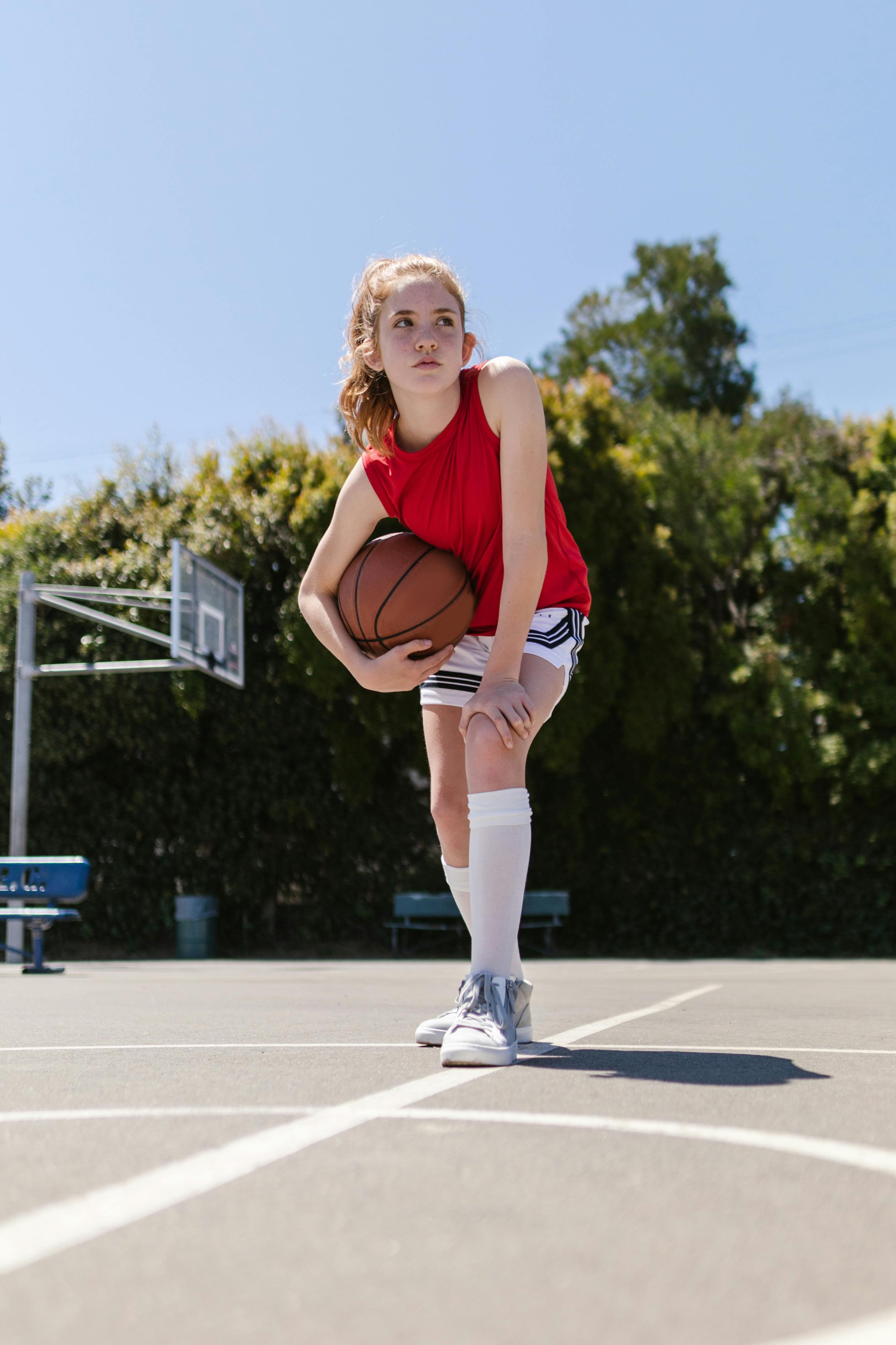 photo of girl holding a ball