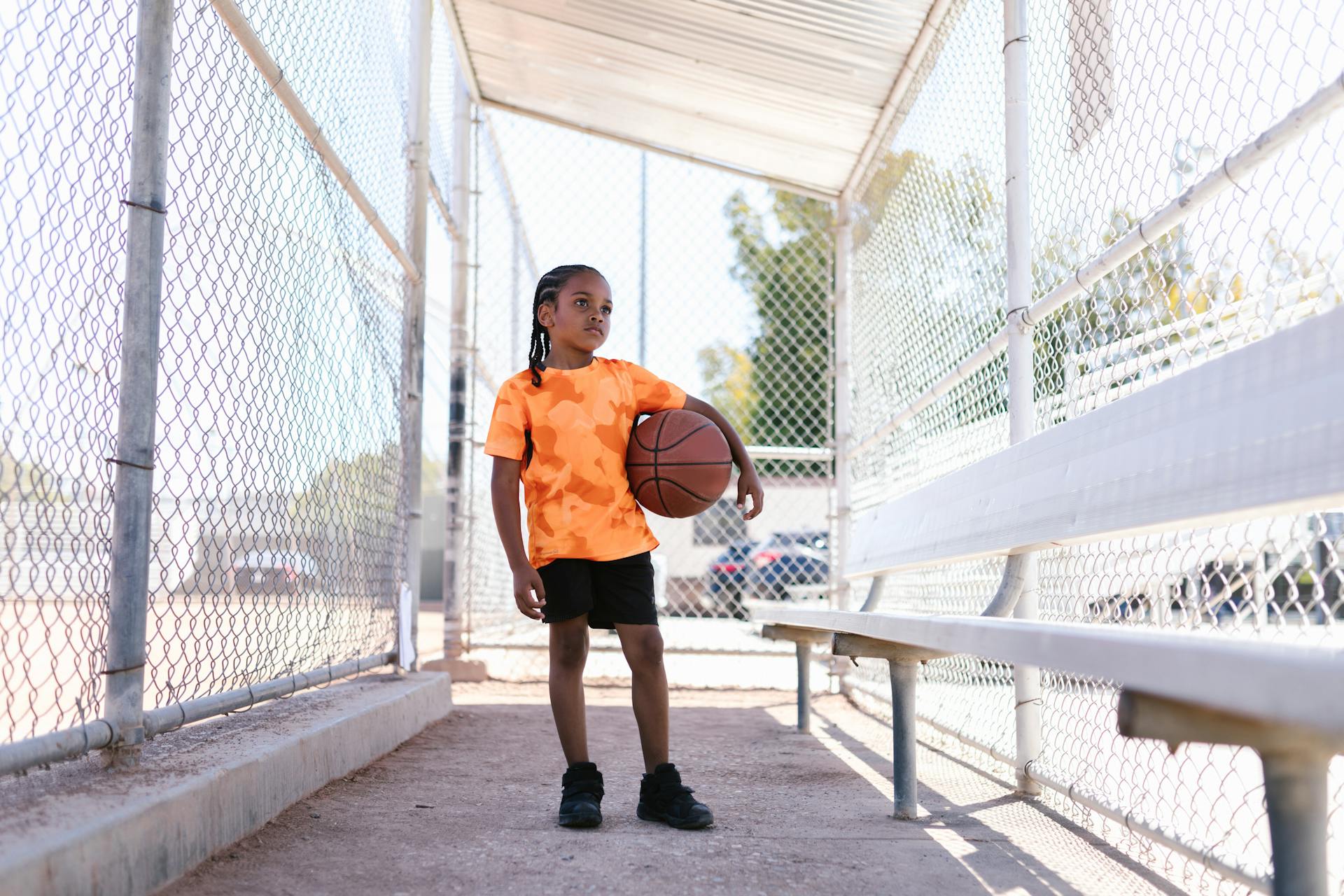 A Kid Standing with a Ball