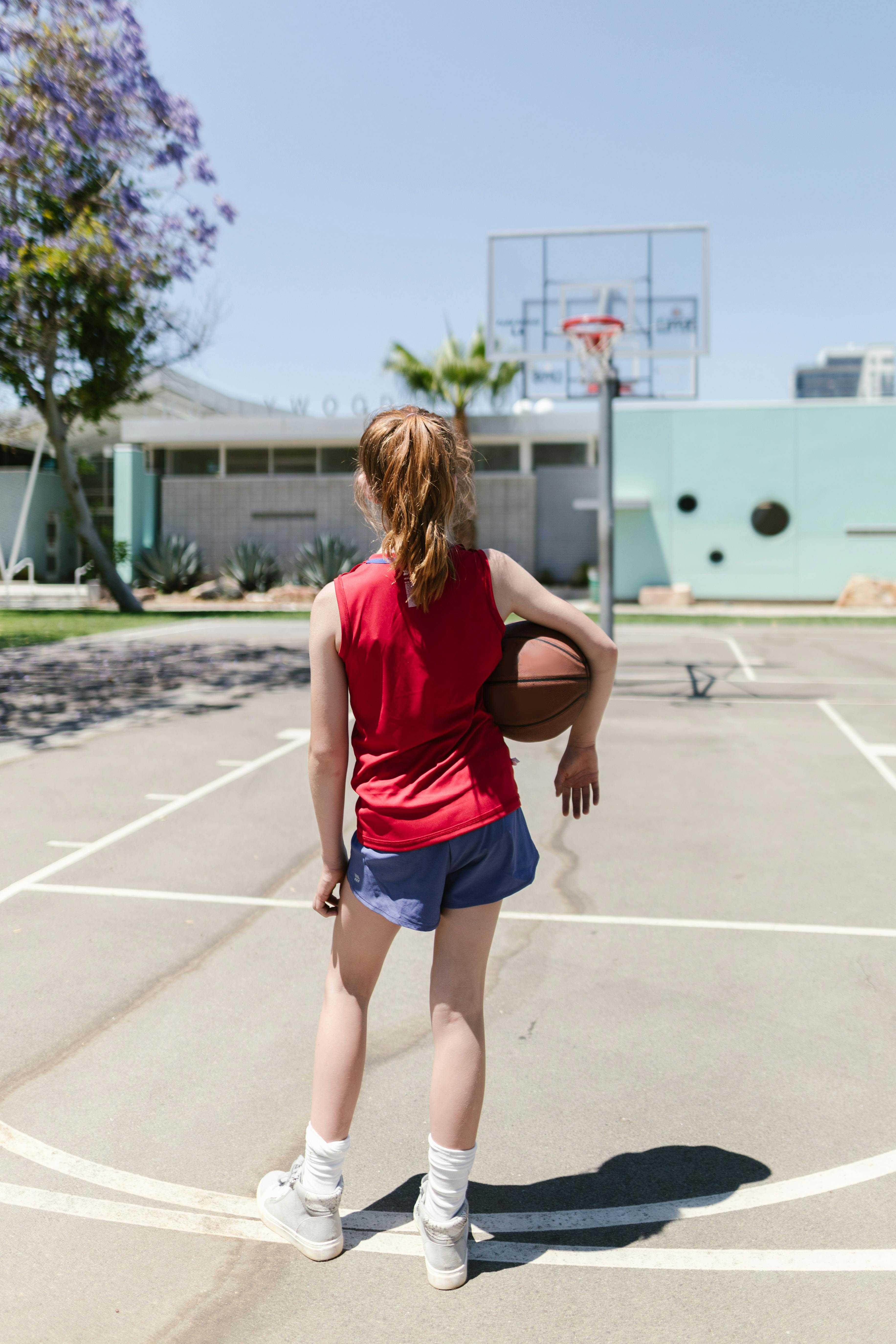 child carrying a basketball