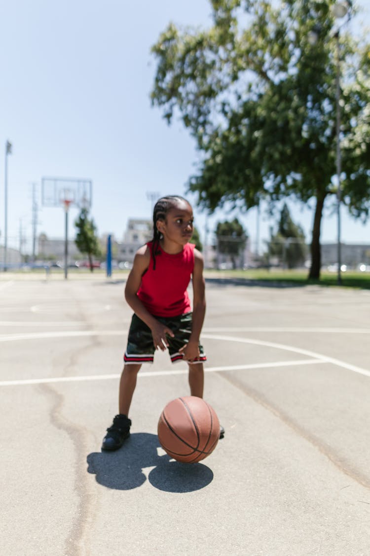 Photo Of A Boy Dribbling A Basketball