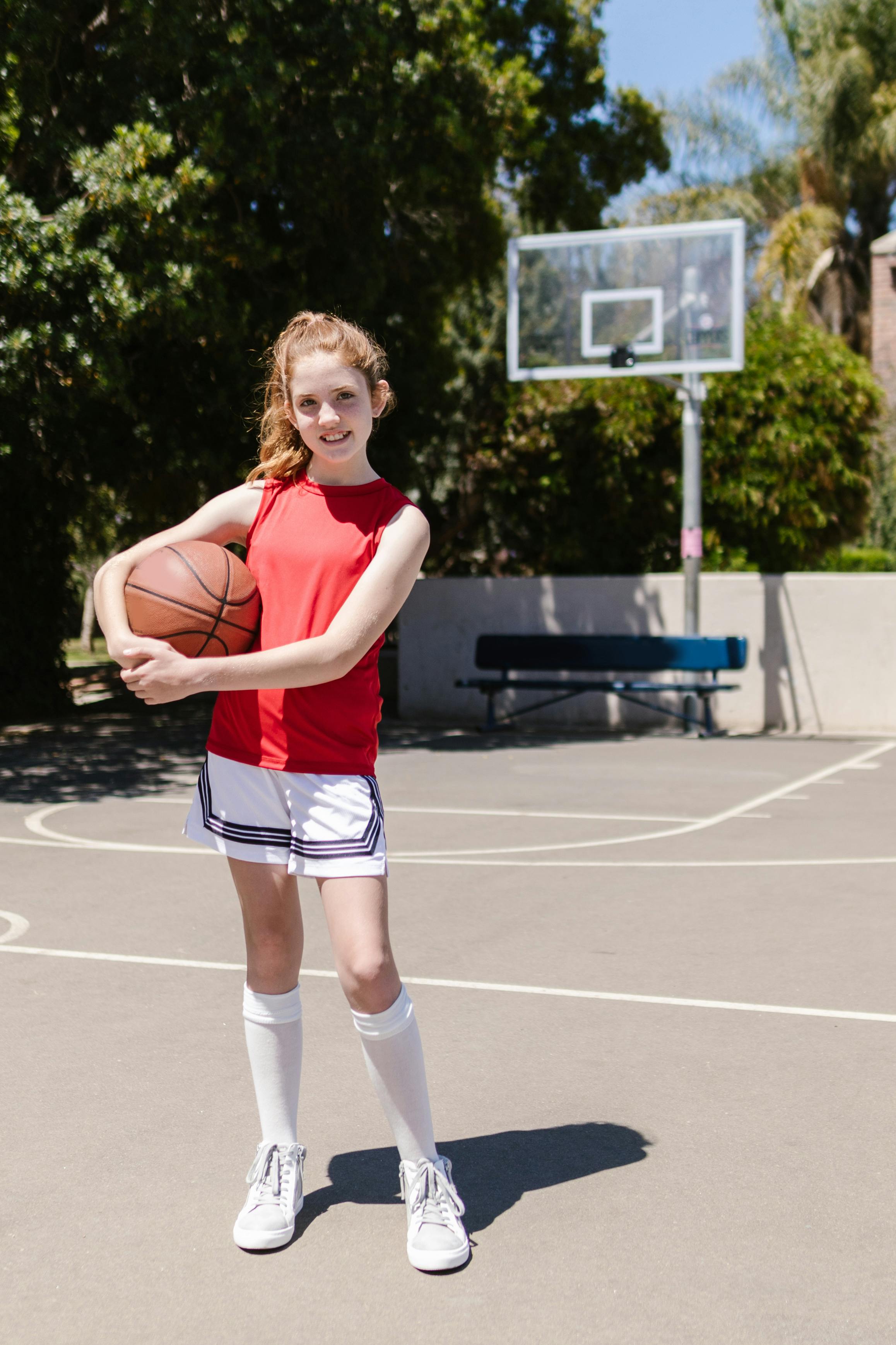 photograph of a girl holding a basketball