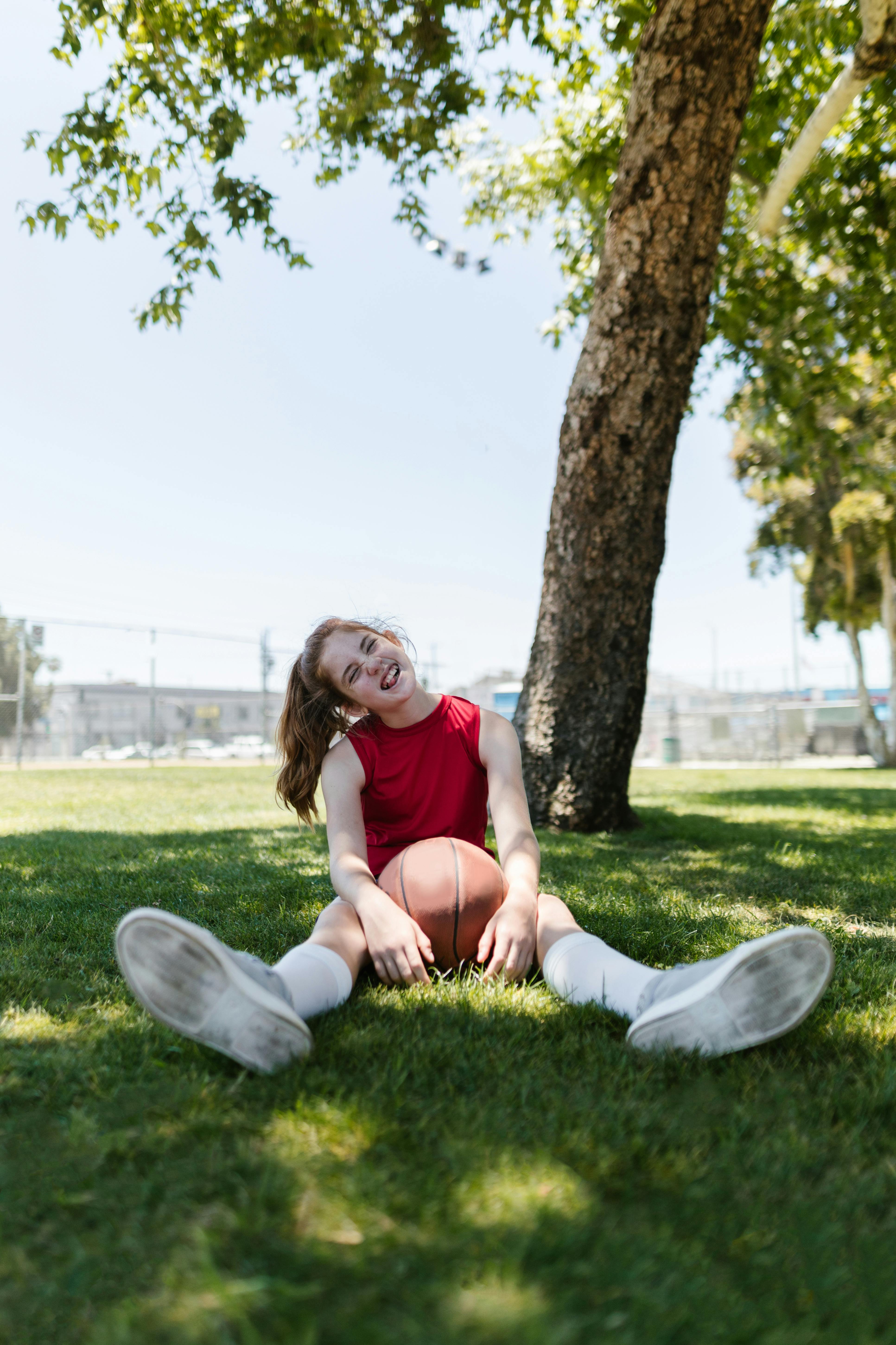 photo of girl holding a ball