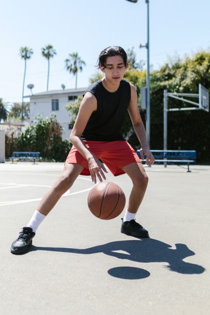 Player dribbling on an outdoor court, photo by RDNE Stock project on Pexels