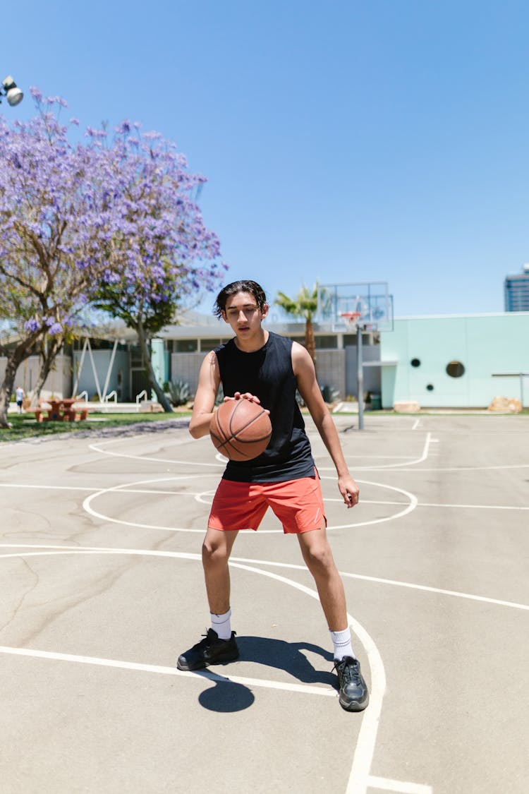 Tall Kid Dribbling A Ball