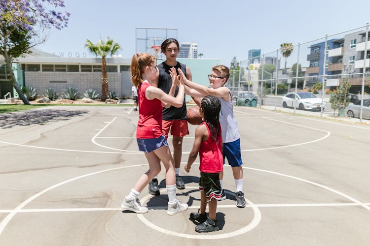 Boys And Girl Standing On The Basketball Court 