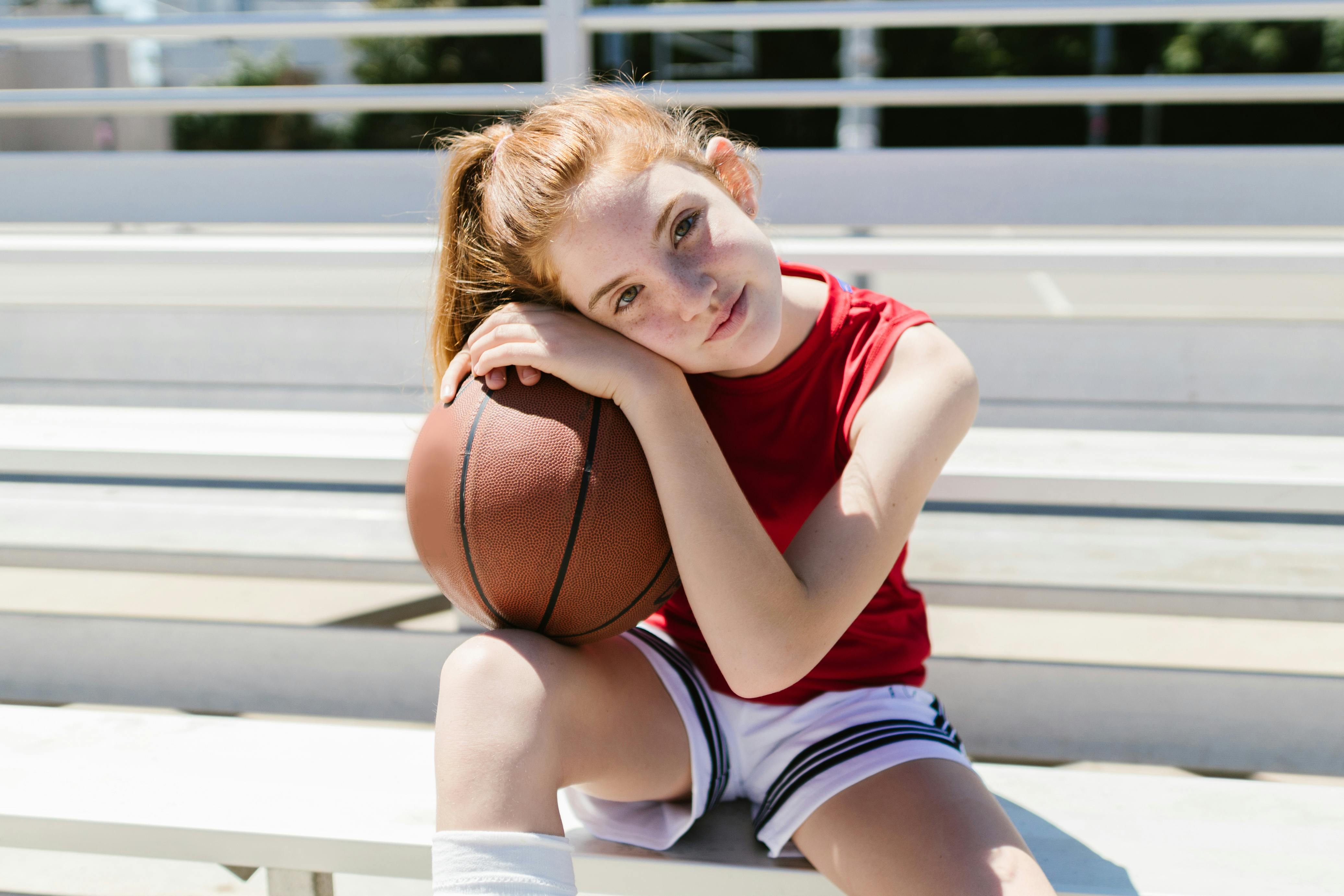 girl leaning on a ball