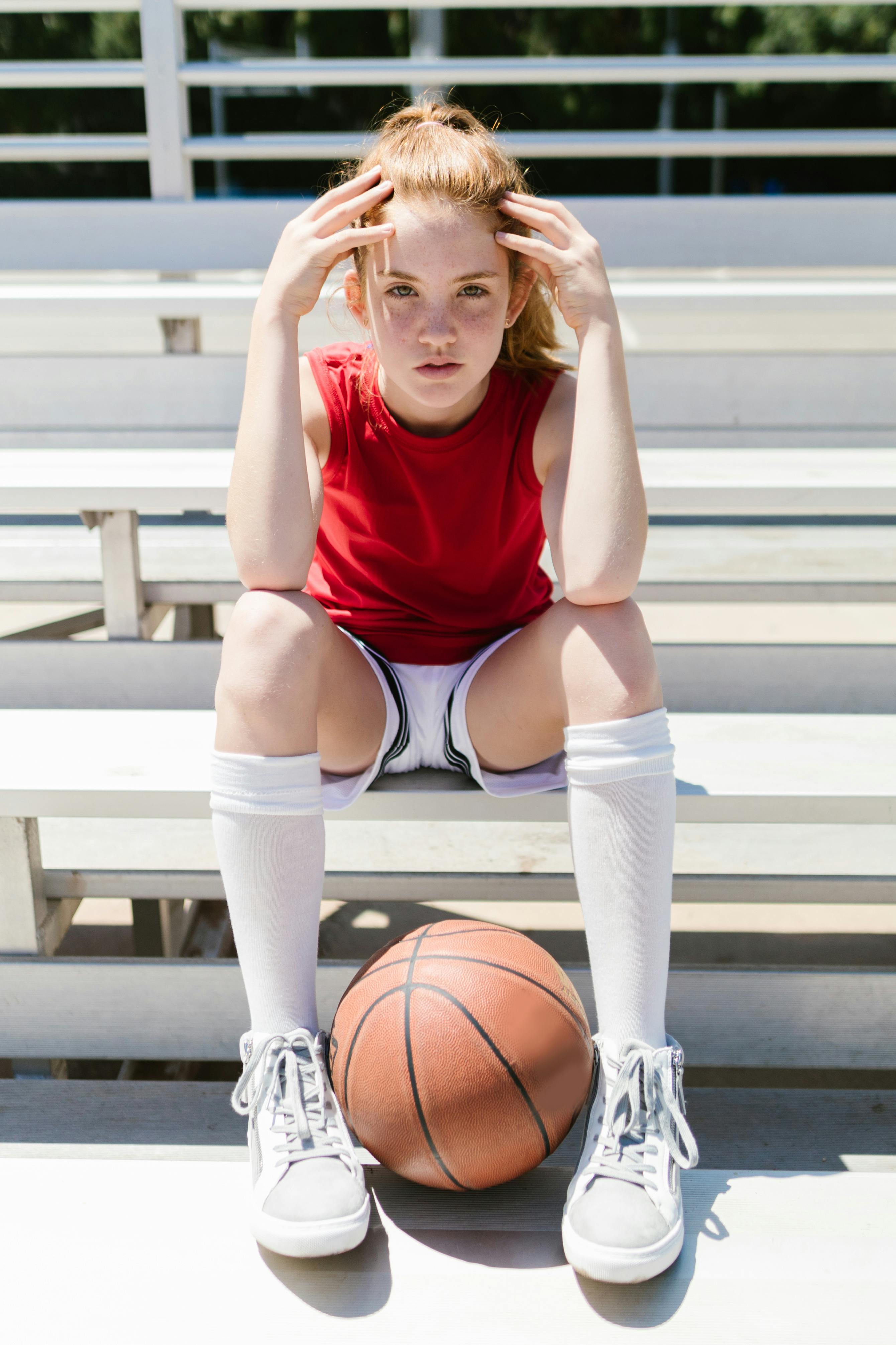 girl sitting on a bleacher