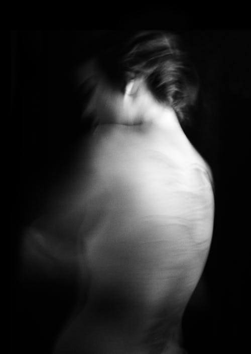 Grayscale Photo of Woman's back