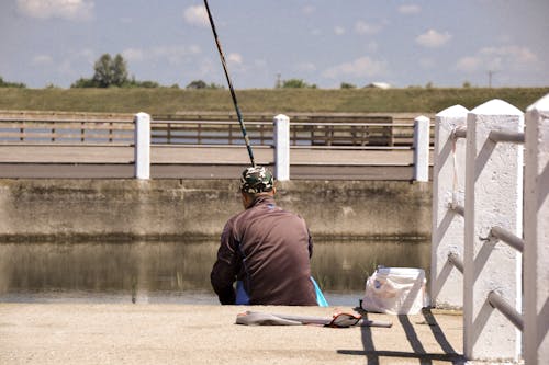Fisherman Sitting by River