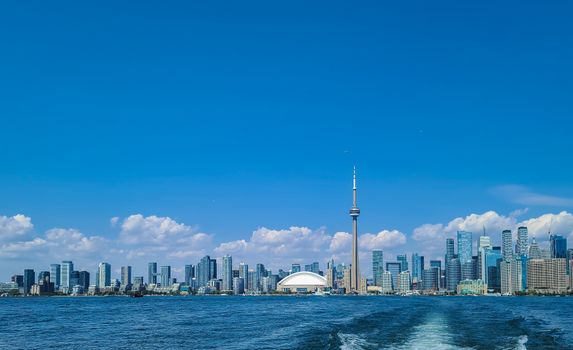 Breathtaking view of Toronto's skyline featuring the CN Tower and the waterfront under a clear blue sky.